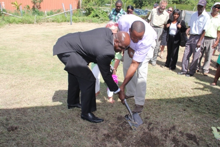Minister of Agriculture Hon. Alexis Jeffers, Friends of ARK Member Mrs Bonnie Berlinghof and Dr. Ambrose James, one of two vets at the Ministry of Agriculture’s Veterinary Service Department on Nevis, turning the sod to signal the start of the Veterinary Clinic Extension project at Prospect Estate on January 30, 2014